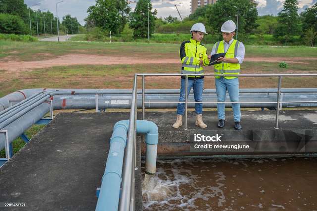 Hawkins-Weir engineers inspecting a wastewater treatment site with a client